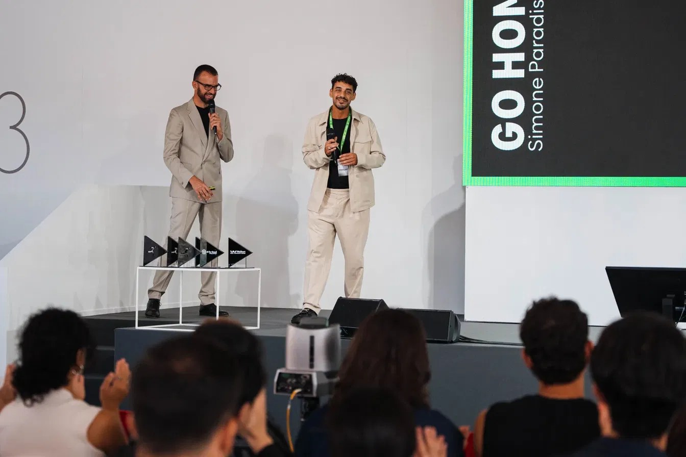 Simone Paradiso on stage presenting Go Home at the Reply AI Film Festival